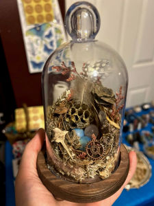 Bone-crafted raven sculpture adorned with crystal shards and gothic lace for a haunting display.