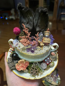 Taxidermy squirrel posed with vintage buttons and thread, a nod to forgotten craftsmanship.